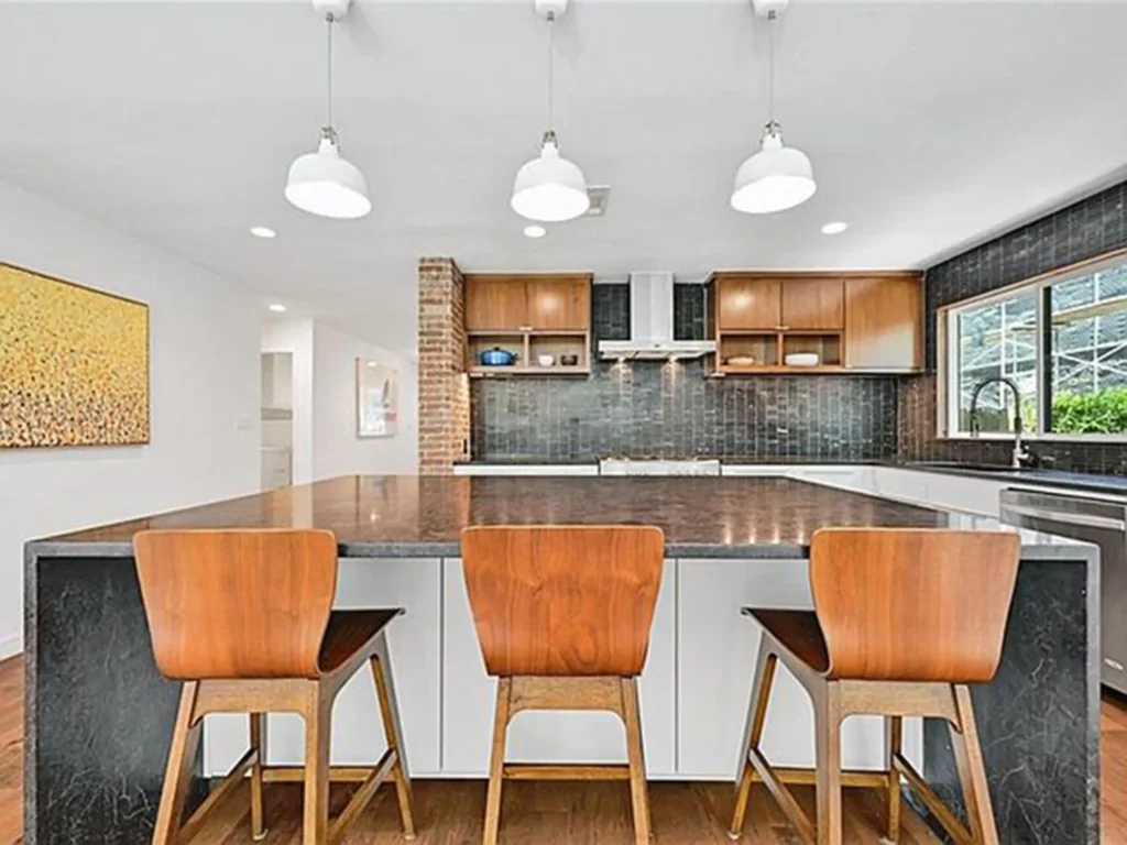 wood and white cabinets combo - black backsplash