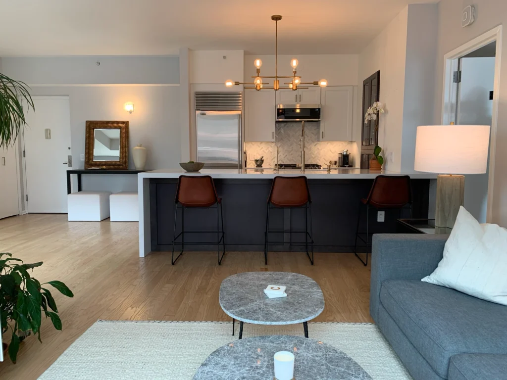 Open living area sofa -kitchen island - leather chairs